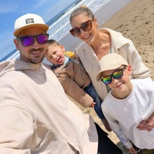 Samuel with his family on the beach 